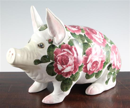 A large Wemyss cabbage rose pattern model of a seated pig, length 43cm, restoration to snout and tail